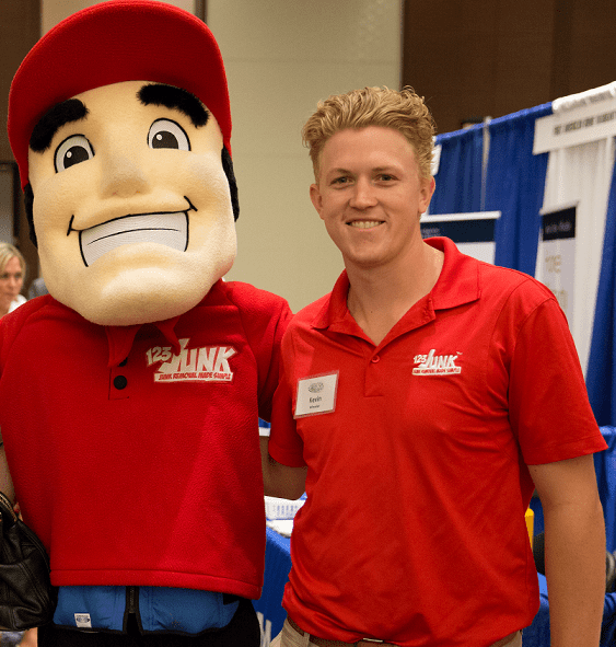 Kevin Wheeler with 123JUNK mascot costume standing next to him wearing a red company polo shirt and name tag