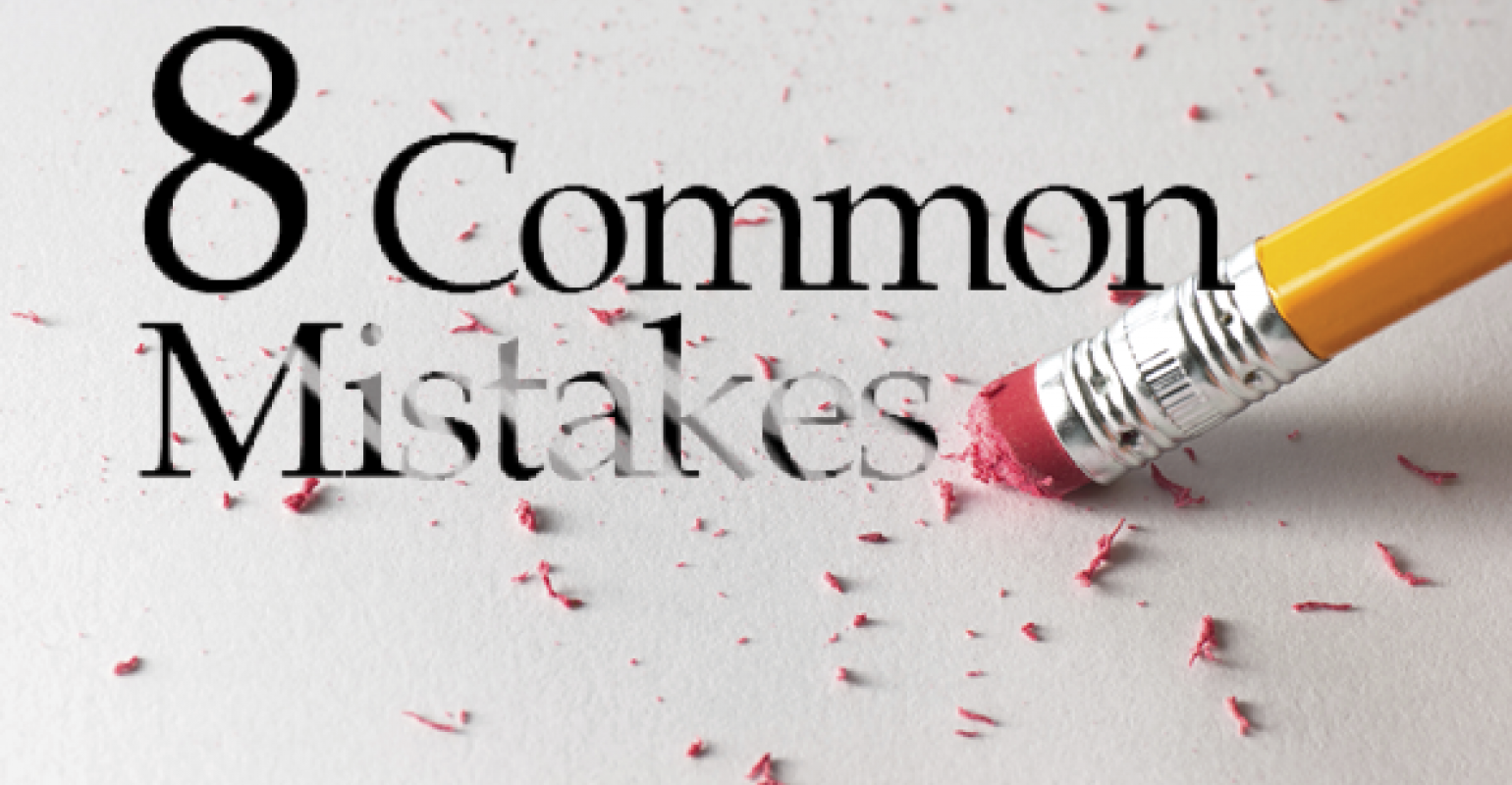 Pencil erasing the words “8 Common Mistakes” with pink eraser shavings scattered across the surface